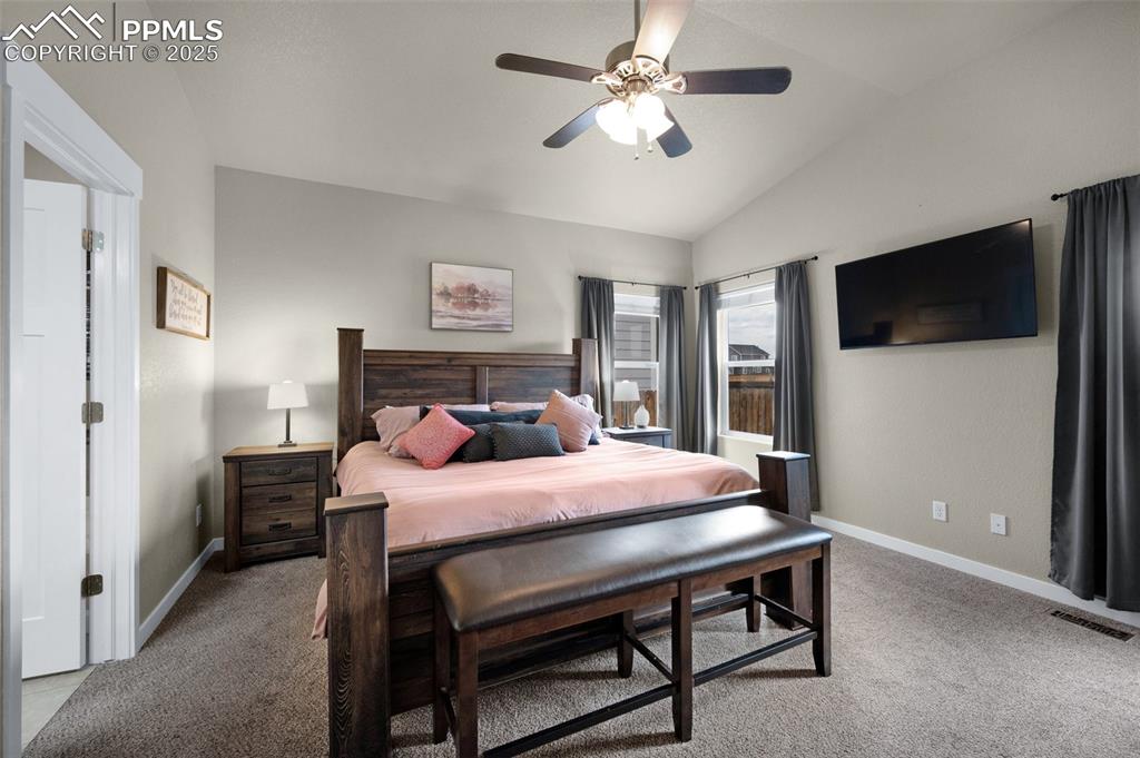 Image 15 of 31: Bedroom with high ceilings, and ceiling fan
