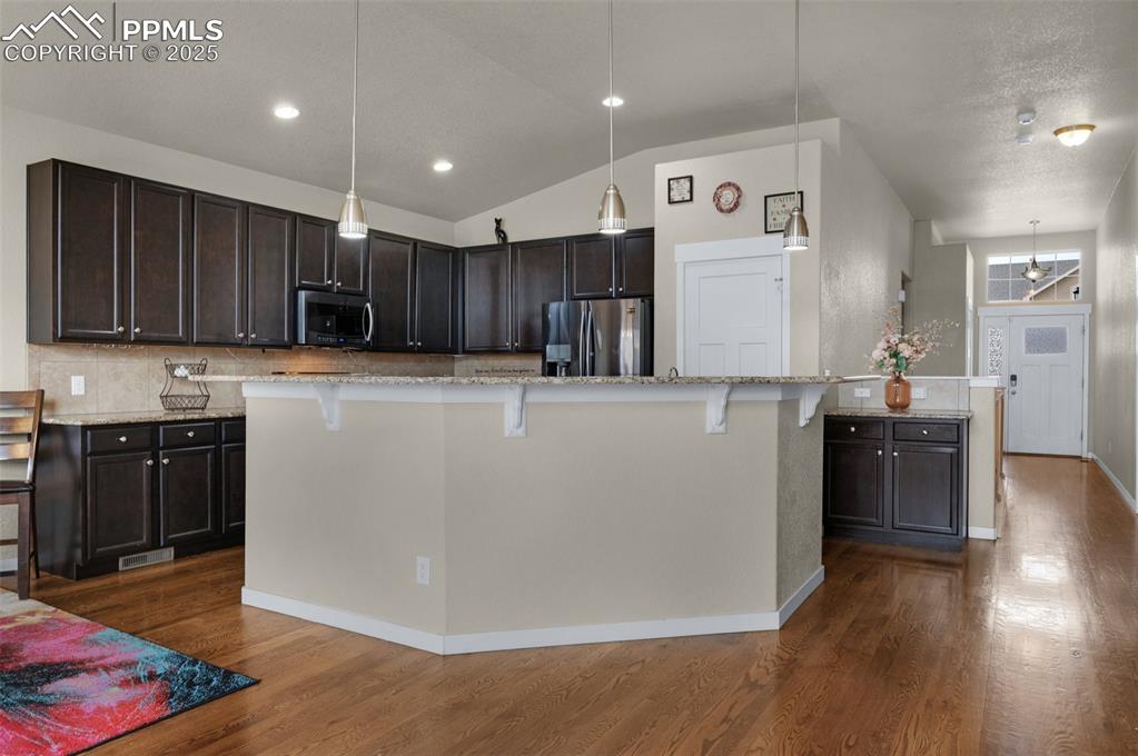 Image 8 of 31: Kitchen with island and breakfast bar