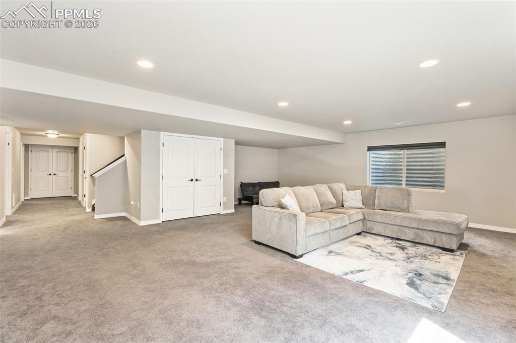 Image 31 of 44: Spacious lower level featuring plush carpeting, recessed lighting, and a wi