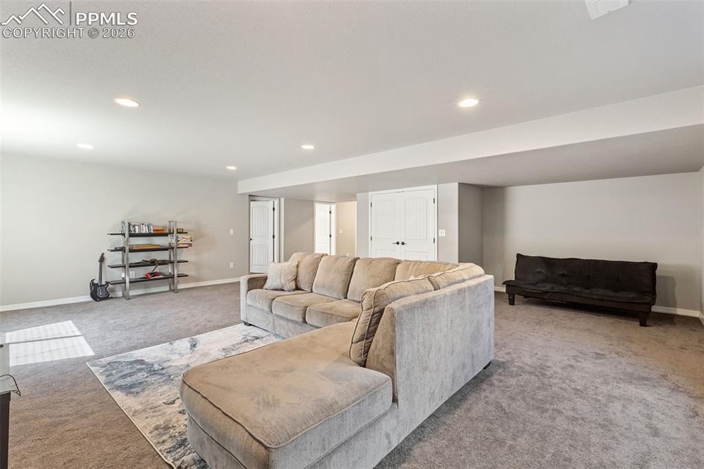 Image 32 of 44: Spacious lower-level area featuring recessed lighting, light gray wall pain
