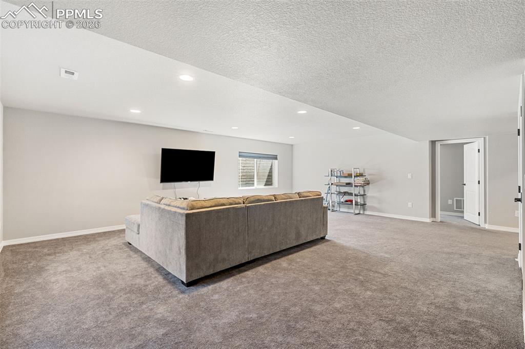 Image 33 of 44: Spacious recreation room featuring recessed lighting, a neutral gray color 