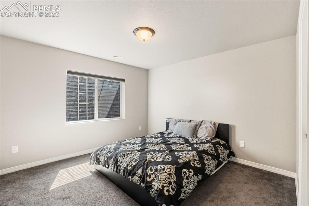 Image 34 of 44: Neutral wall color with a single window, white trim, and a flush mount ceil