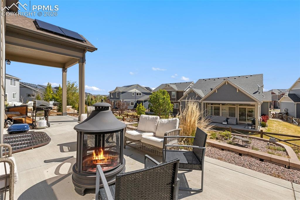 Image 38 of 44: Expansive concrete patio featuring a covered area with recessed lighting an