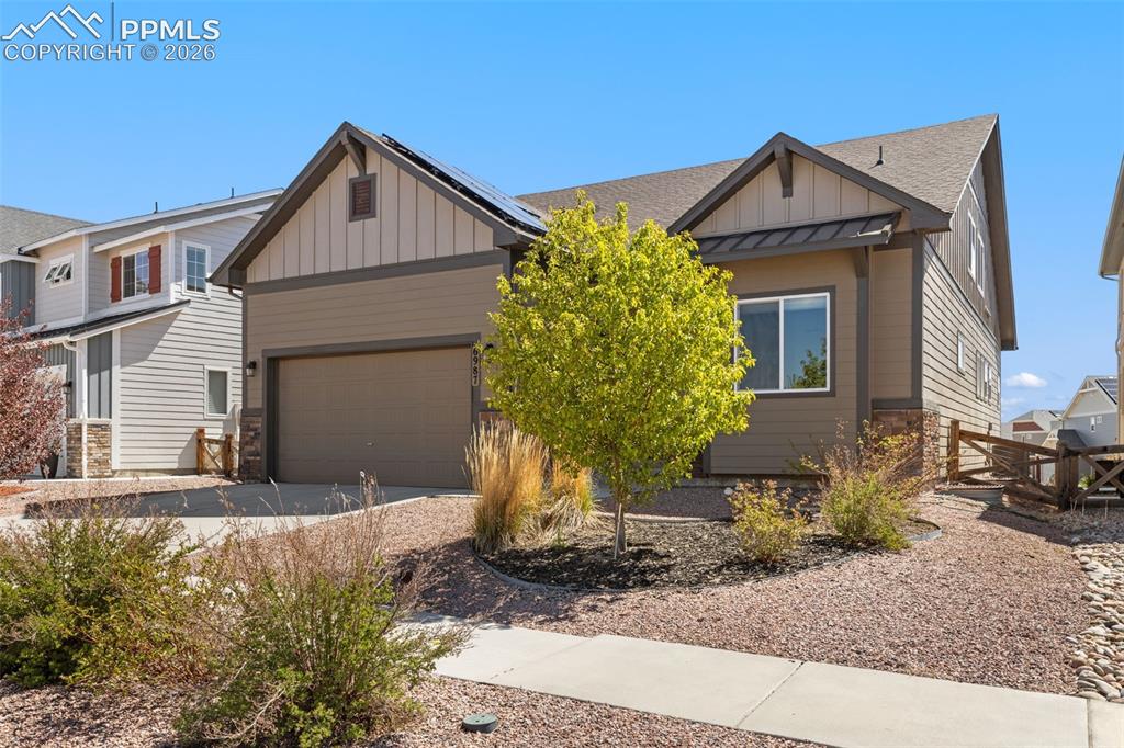 Image 5 of 44: Modern craftsman-style exterior featuring a two-car garage, solar panels, a