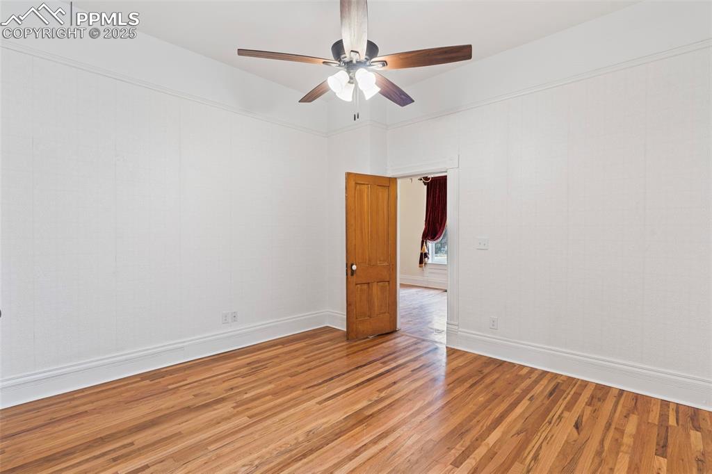 Image 15 of 36: Unfurnished room featuring wood finished floors and a ceiling fan