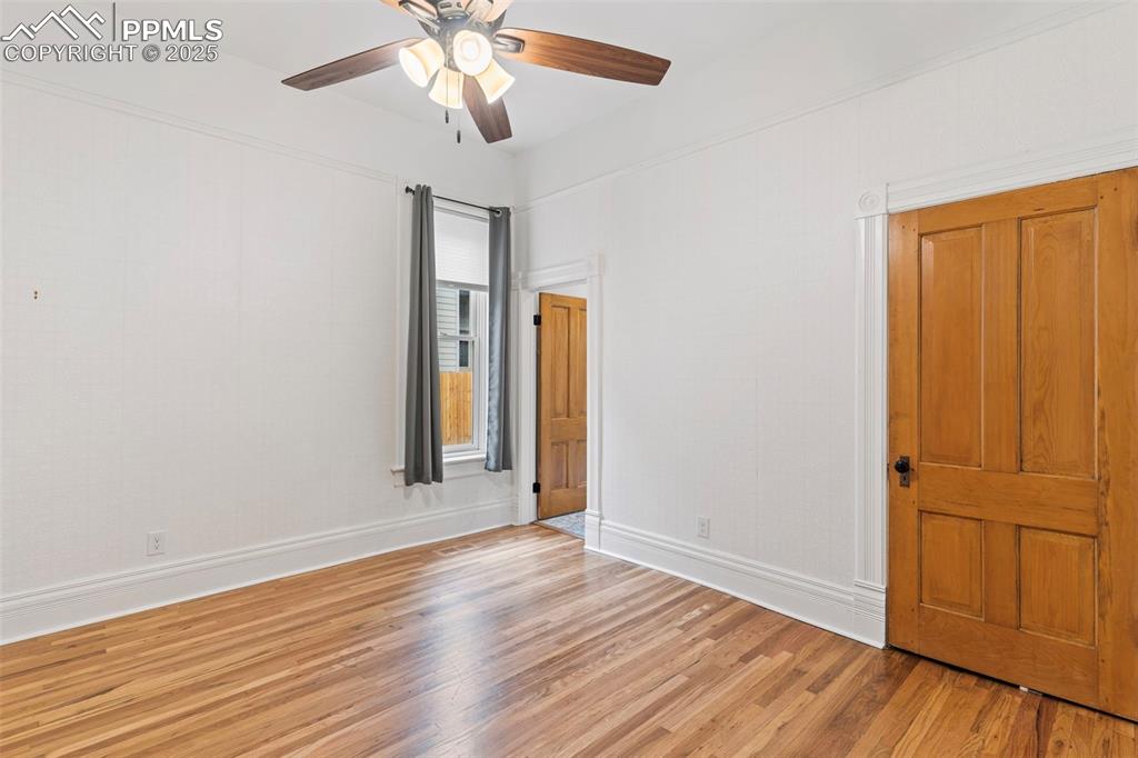 Image 21 of 36: Unfurnished bedroom with light wood-style floors and ceiling fan