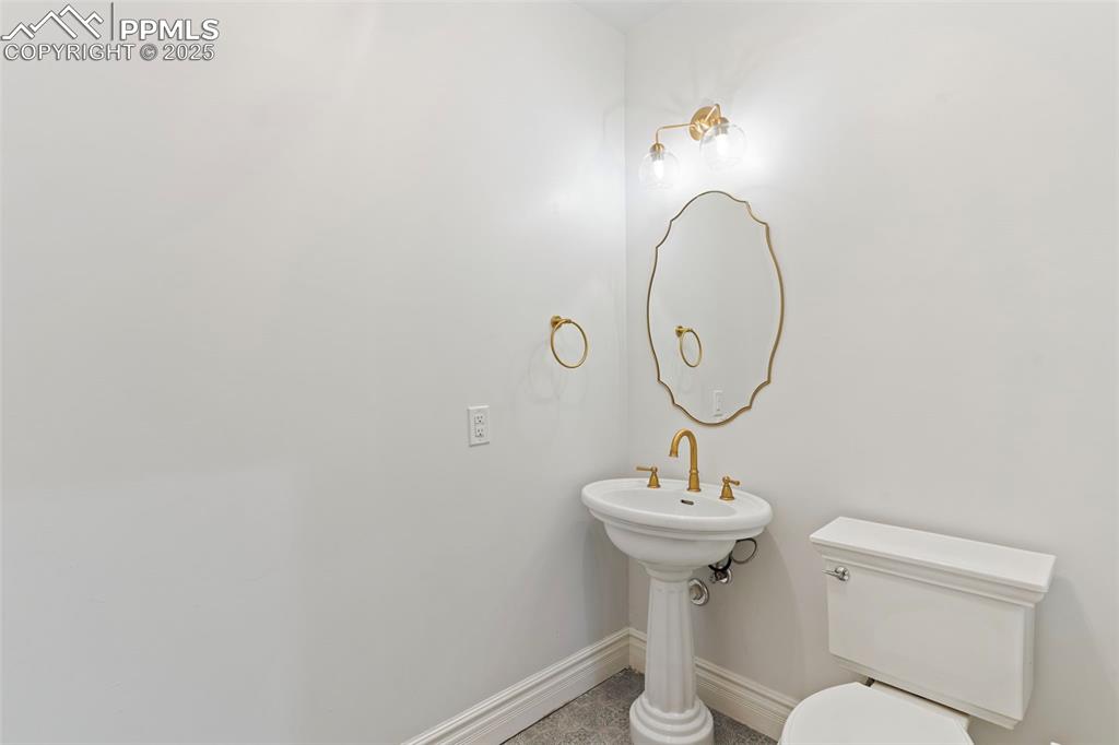 Image 24 of 36: Bathroom with toilet and tile patterned flooring