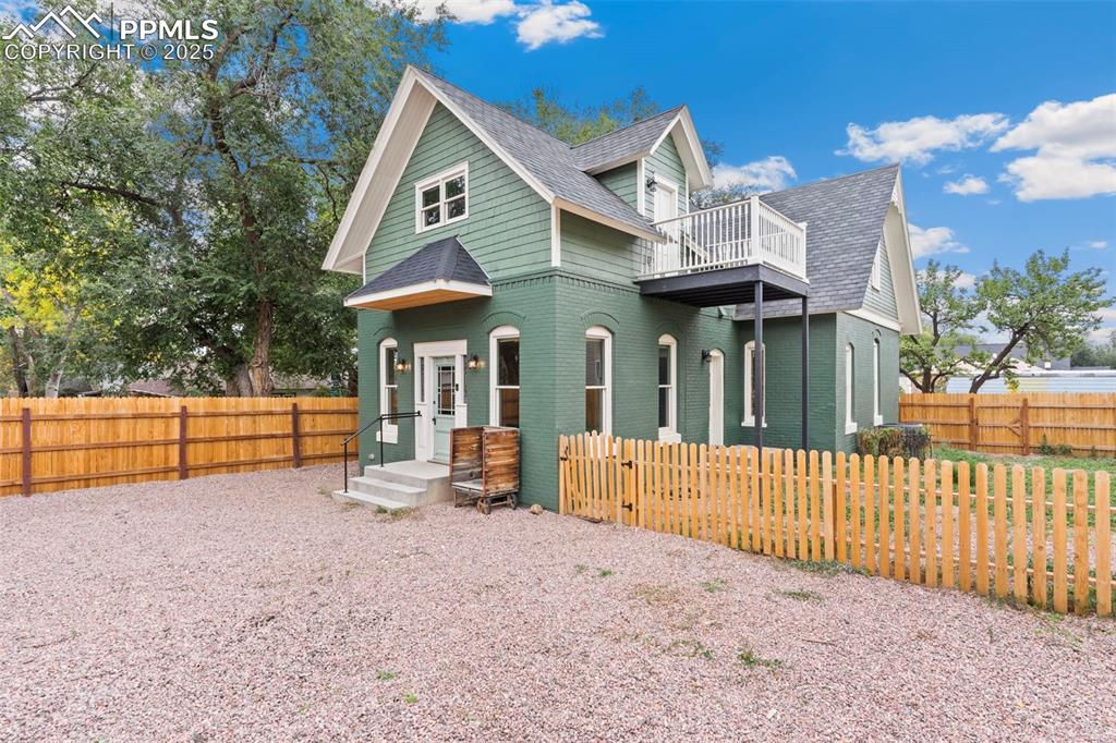 Image 31 of 36: View of front of house with a shingled roof and brick siding