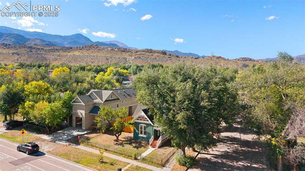 Image 34 of 36: Aerial view of property and surrounding area with a mountainous background