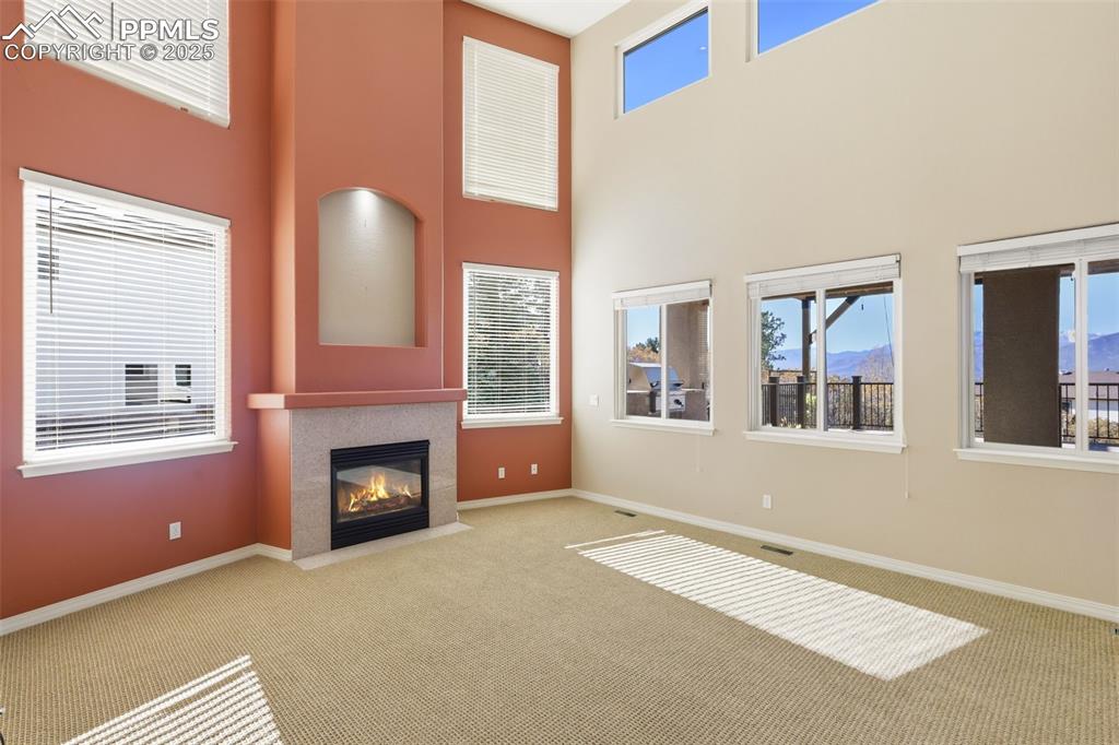 Image 19 of 50: Two Story Great Room with Gas Fireplace and an Abundance of Natural Light!