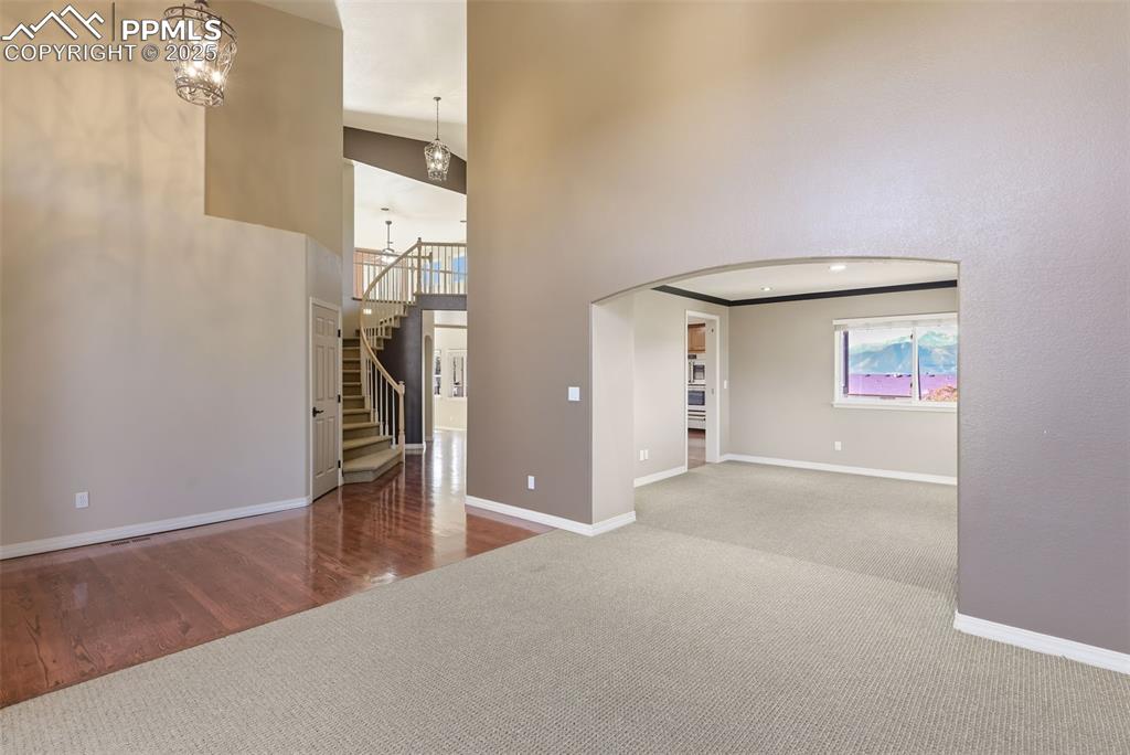 Image 22 of 50: Formal Living Room with 2 Story Soaring Ceiling!