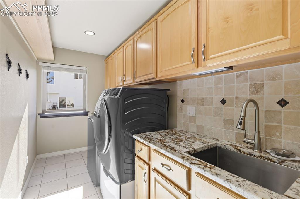 Image 25 of 50: Fabulous Main Level Laundry Room Boasting Custom Maple Cabinetry ~ Granite 
