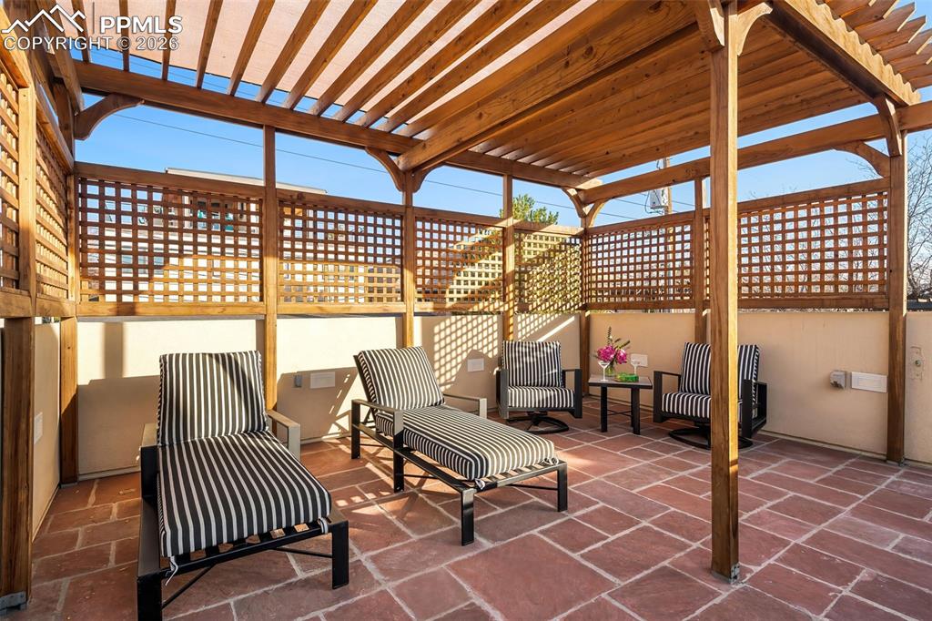 Image 38 of 50: Upper Level Patio With NEW Pergola