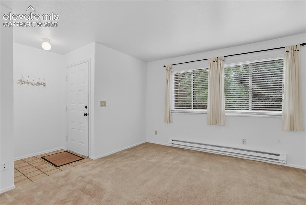 Image 8 of 34: View of living room from dining room.
