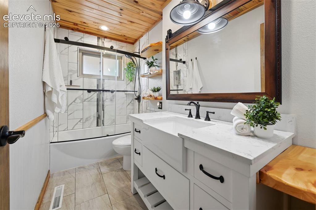 Image 34 of 50: Main level bathroom with Black forect beetle kill pine ceilings