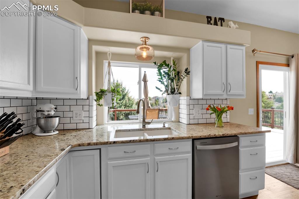 Image 12 of 50: An absolute pleasure to do dishes with this view! Walk out to the large dec