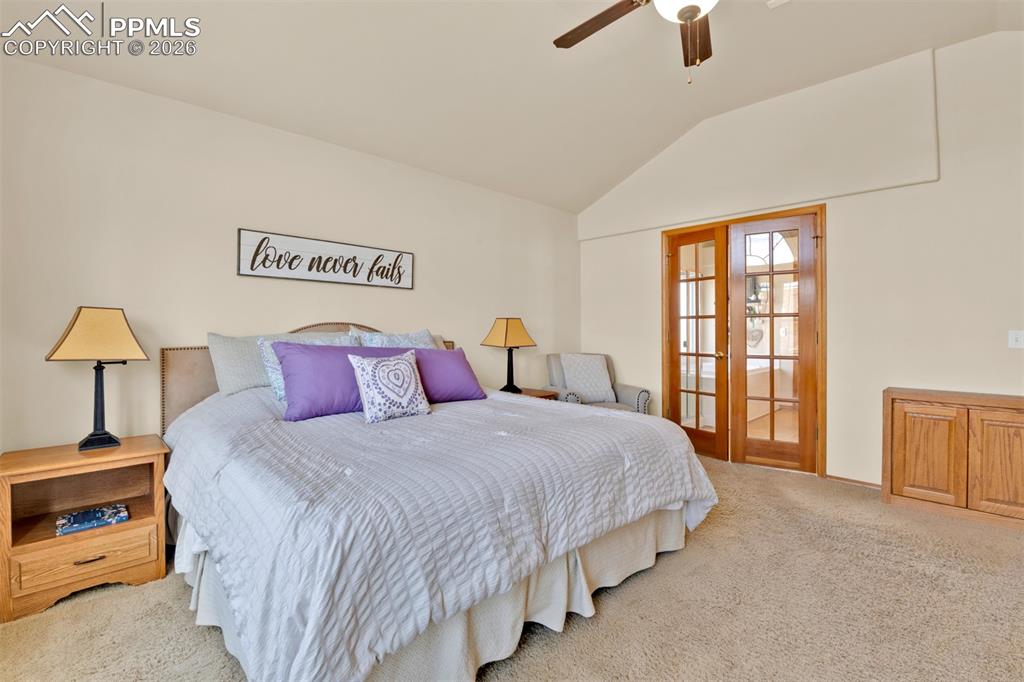 Image 21 of 50: Primary bedroom with vaulated ceilings and private retreat bathroom.