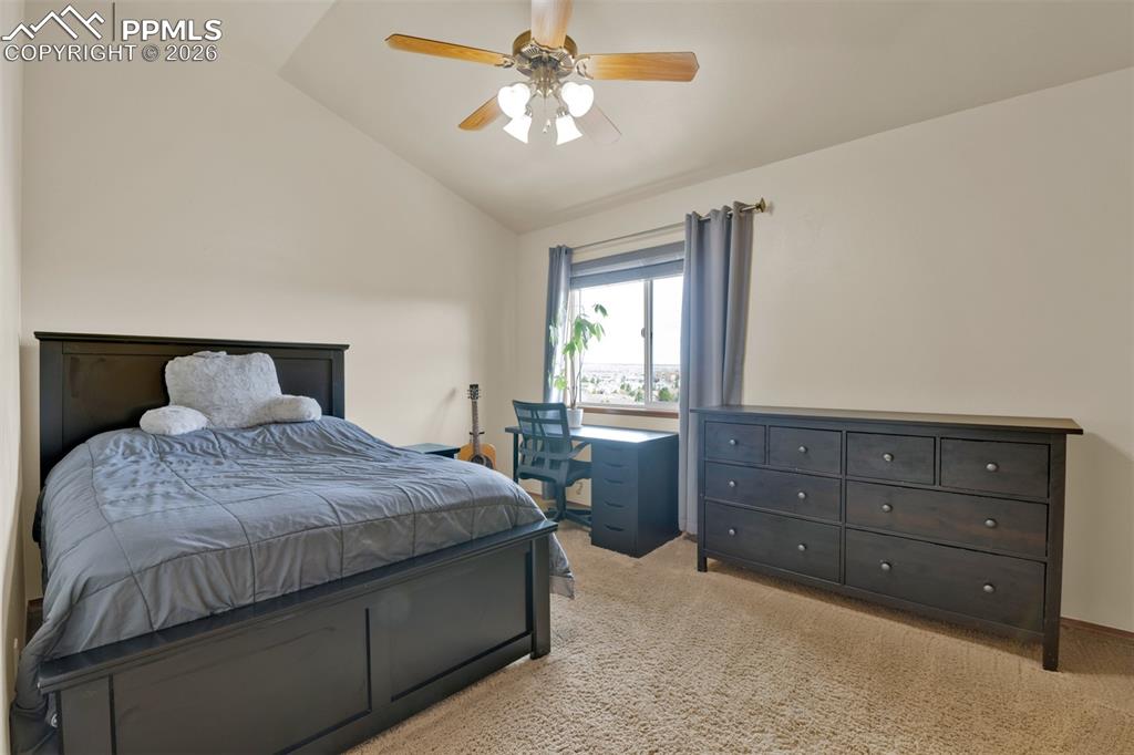 Image 26 of 50: Upstairs secondary bedroom #1 with fresh paint, vaulted ceilings, large clo