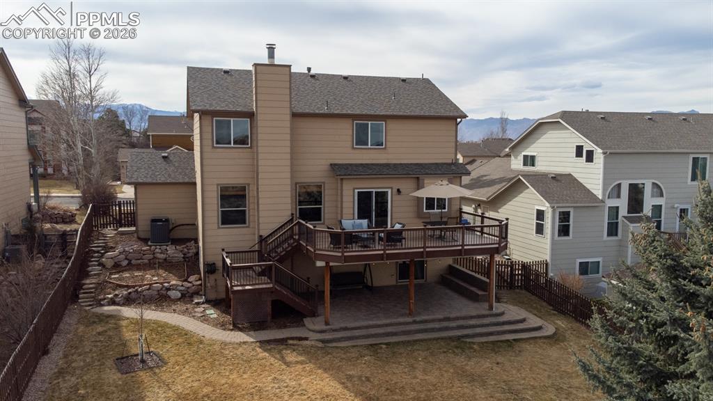 Image 37 of 50: Beautifully fully landscaped yard with expansive composite deck, covered pa