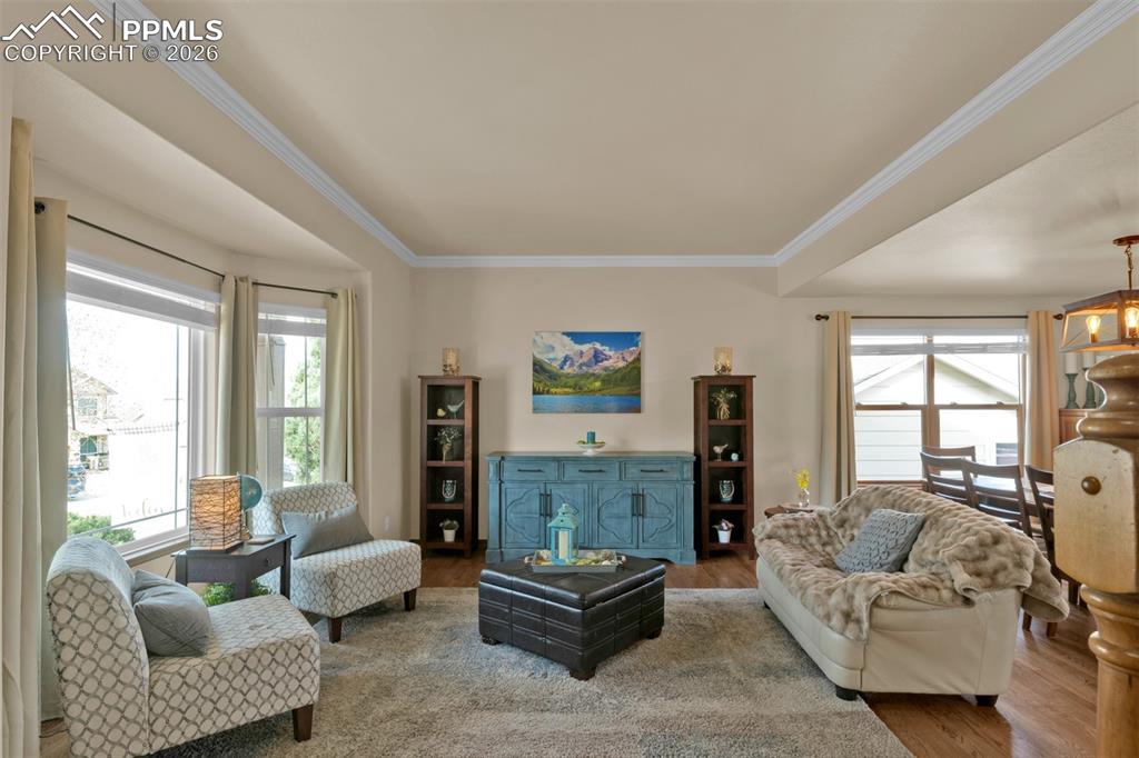 Image 4 of 50: Front formal living area with bay window and beautiful hardwood floors.