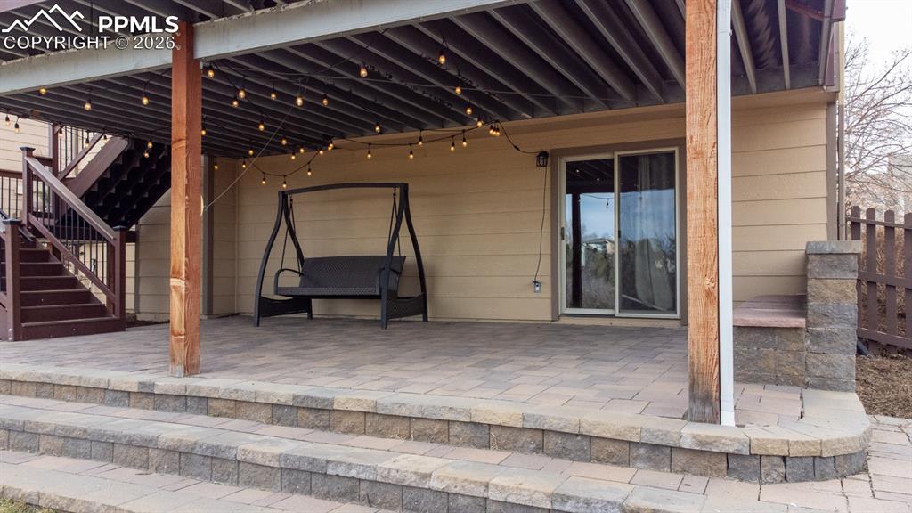 Image 43 of 50: Covered beautiful paver patio with rain drain system so it stays dry even i