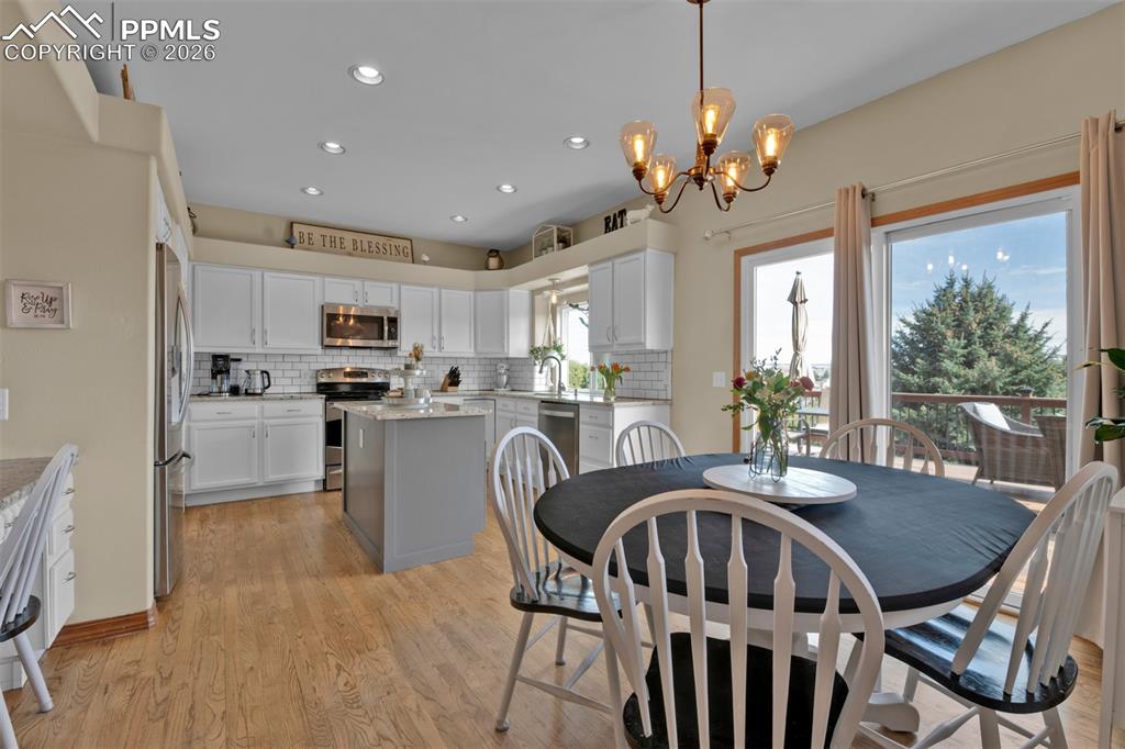 Image 9 of 50: Eat-in breakfast area with walk-out to large deck.
