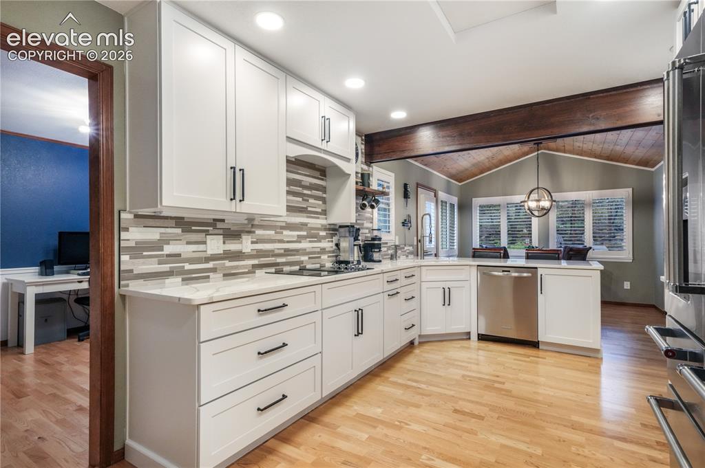 Image 12 of 50: Upper living room with views into kitchen and formal dining