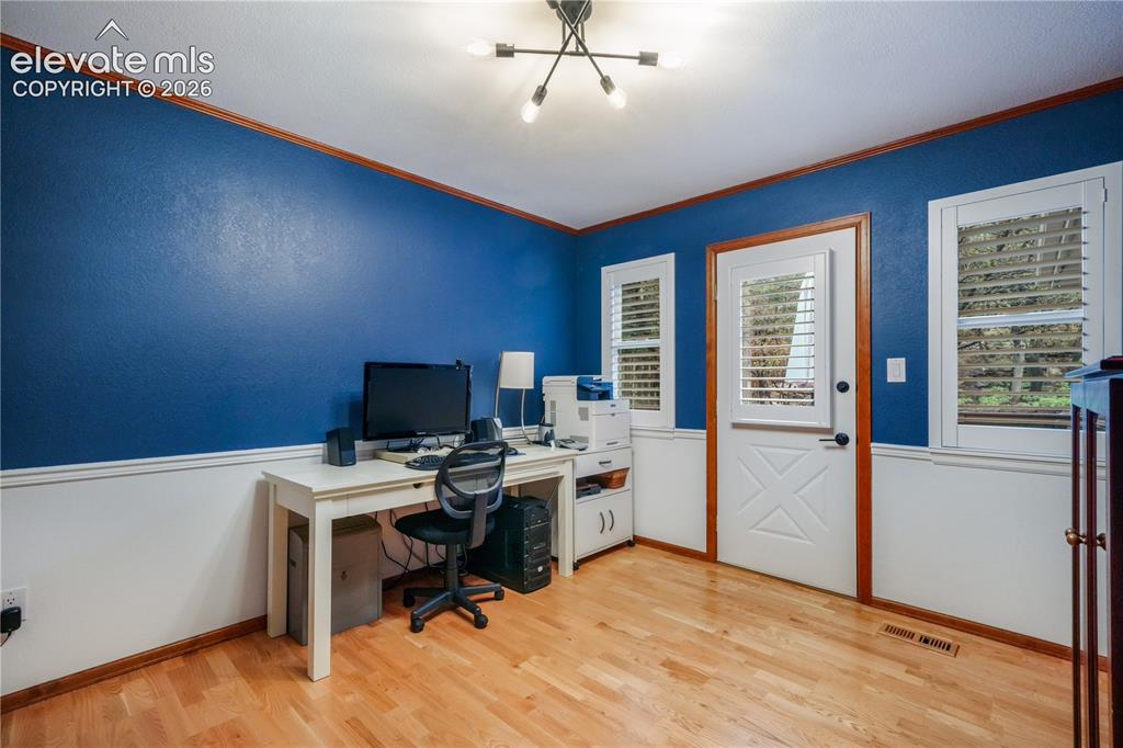 Image 13 of 50: Kitchen with updated appliances including double oven, beautiful wood beams