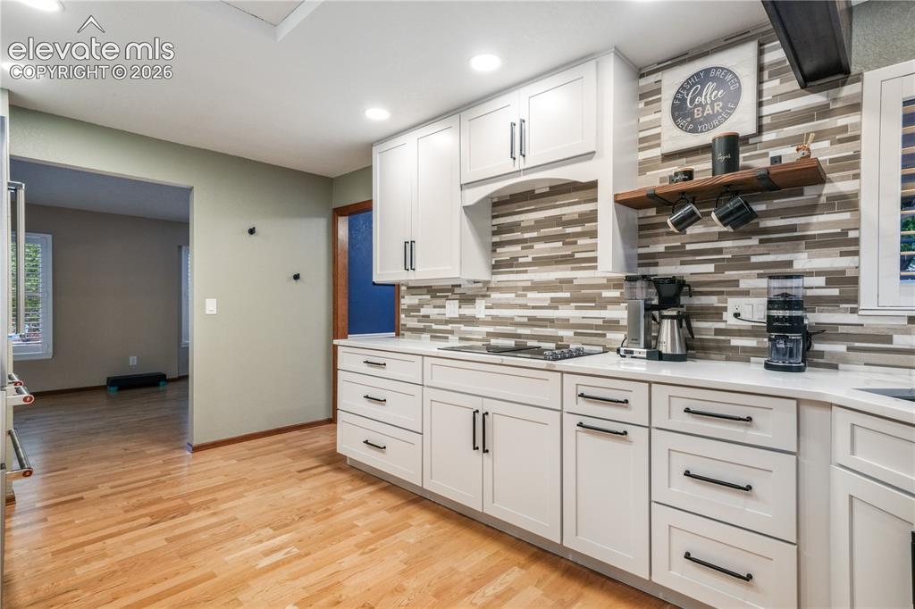 Image 15 of 50: Kitchen view showing access to formal dining room, eat in kitchen and walk