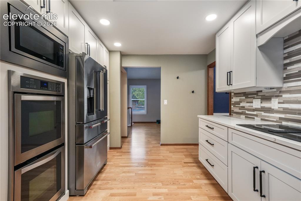 Image 16 of 50: Formal dining room or office with access to back deck