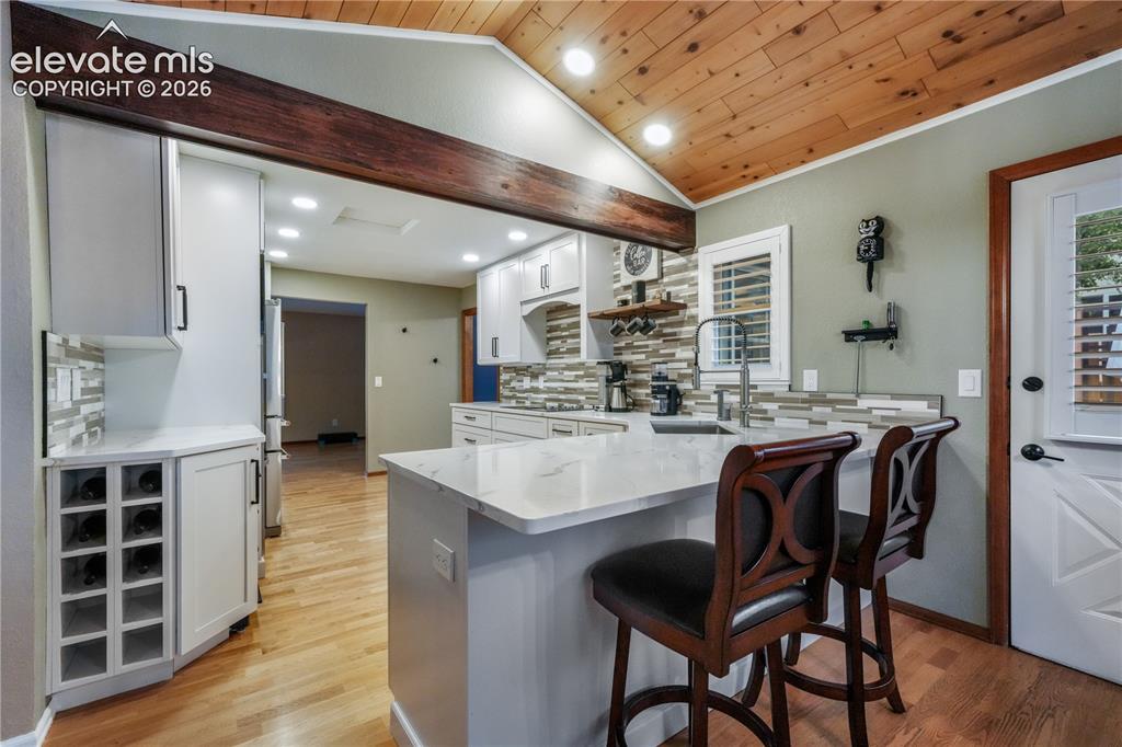Image 18 of 50: Kitchen with view of living room and entrance to formal dining area