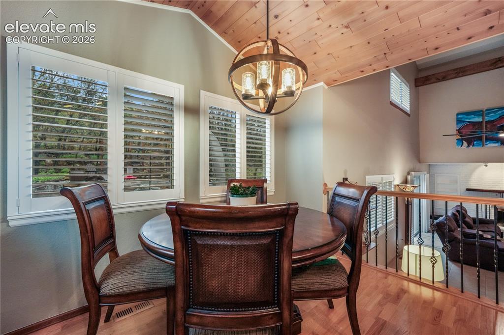 Image 19 of 50: Kitchen with updated appliances including double oven showing view into upp