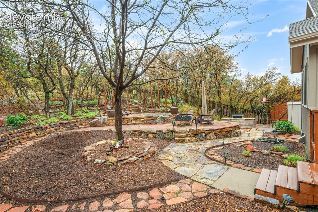 Image 44 of 50: Back of home showing multiple seating and entertaining areas