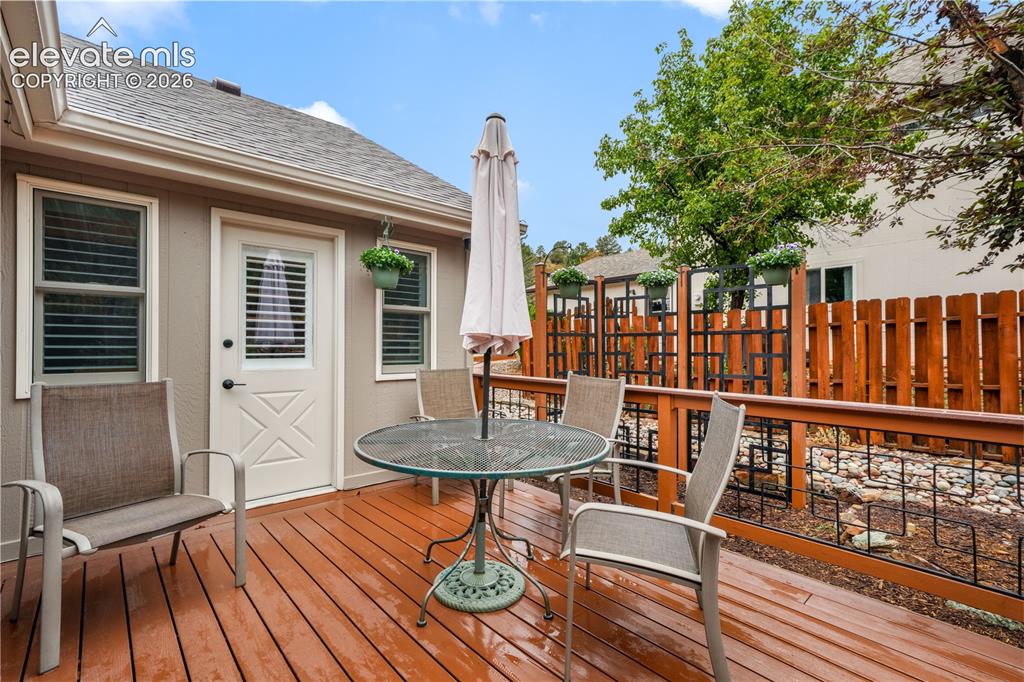 Image 46 of 50: Back yard showing multiple seating areas, fire pit and garden area