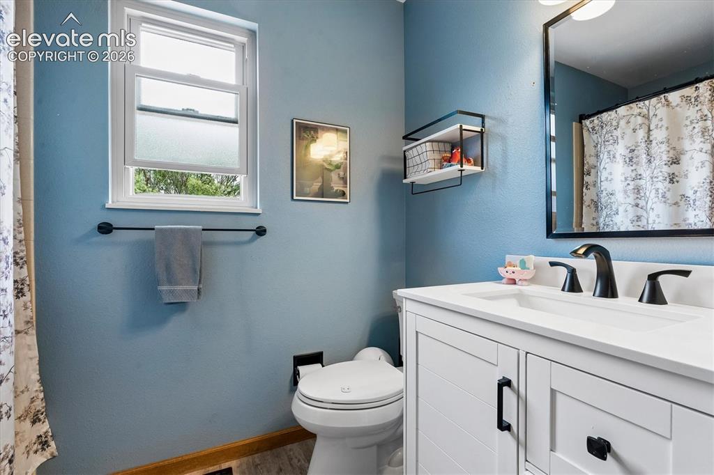 Image 17 of 30: Hall bath on main floor new vanity, flooring and toilet