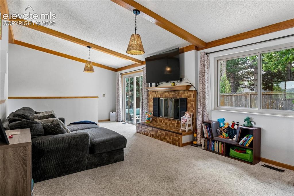 Image 8 of 30: Family room with access to patio