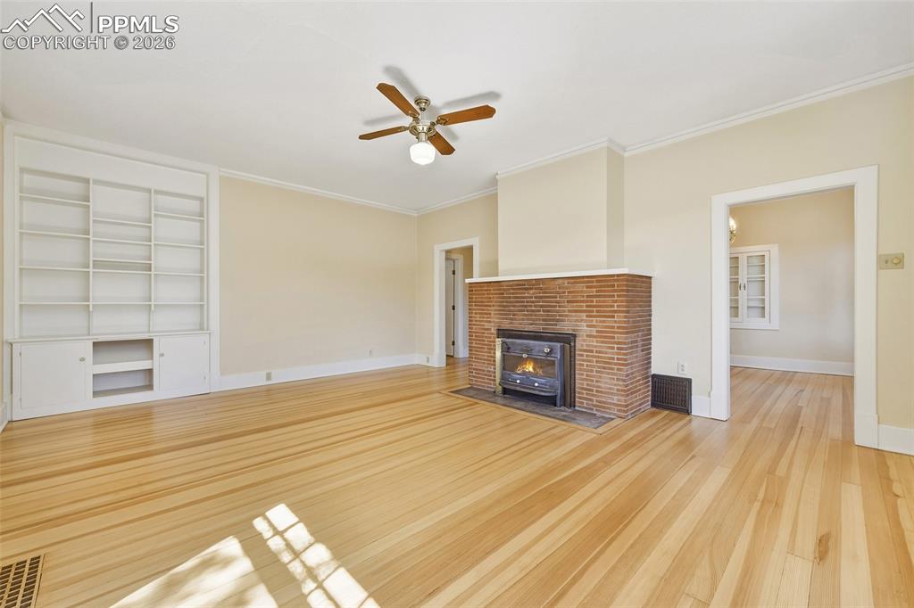 Image 14 of 47: Living Room Showing Built-Ins, Fireplace, And Entry Into Dining Room 