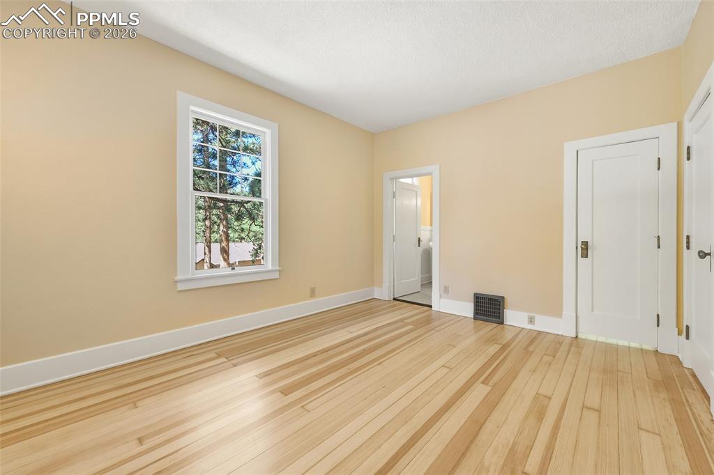 Image 24 of 47: Primary Bedroom With View Of Door To Walk-In Closet