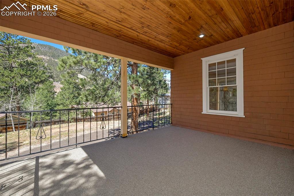 Image 8 of 47: Covered Deck/Porch With View Of Back Yard And The Mountains