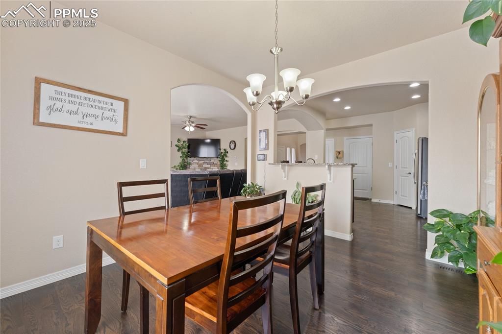 Image 11 of 38: Dining area featuring wood floors and arched walkways