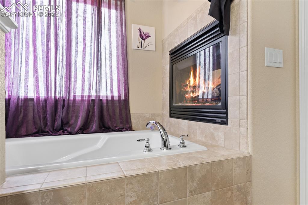 Image 22 of 38: 5 piece bathroom with a garden tub, double vanity w granite counters, tile