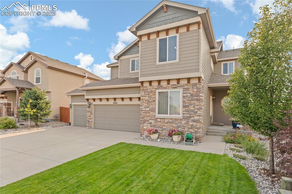 Image 3 of 38: Immaculate landscaping and 4 car tandem garage