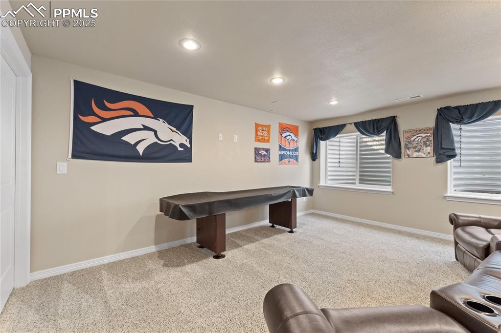 Image 33 of 38: Basement family room with wet bar