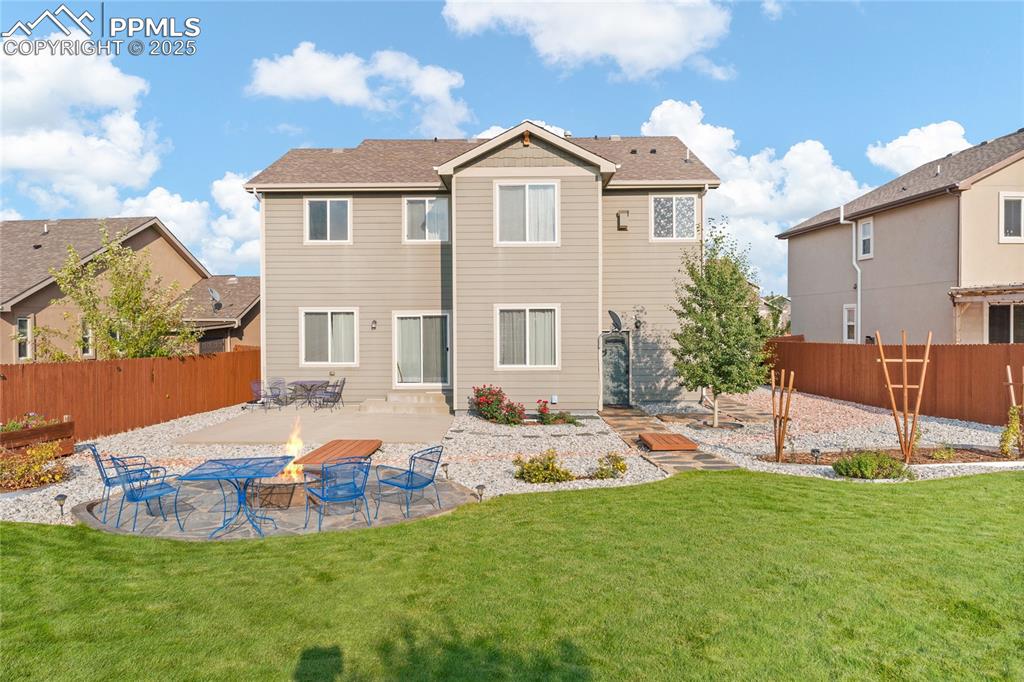 Image 38 of 38: Back of house with a patio area, a fenced backyard, and an outdoor fire pit
