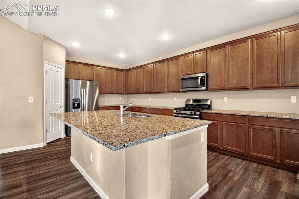 Image 12 of 41: Island with breakfast bar & stainless steel appliances.