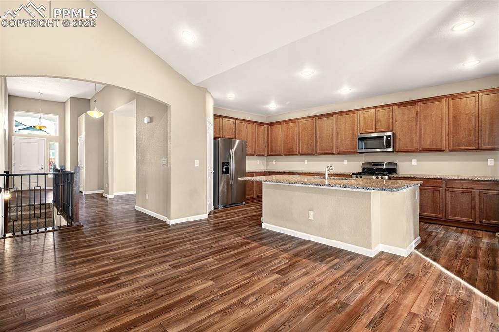 Image 16 of 41: From the living room looking towards the front door, dining room and kitche