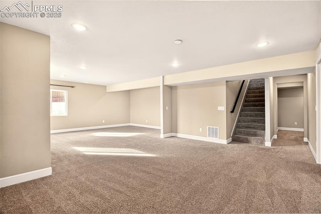 Image 28 of 41: Family room and hall to bedrooms.