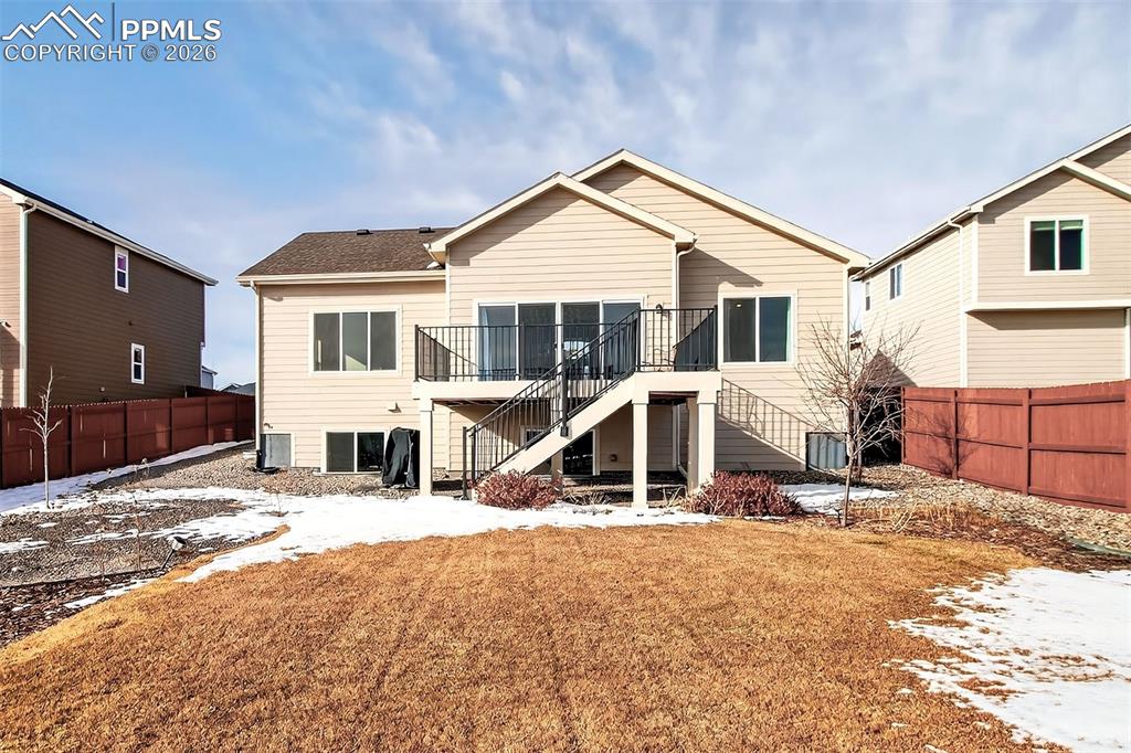 Image 36 of 41: Landscaped yard with composite deck.
