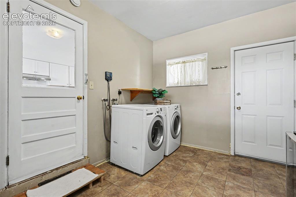 Image 14 of 36: Laundry room off of kitchen.