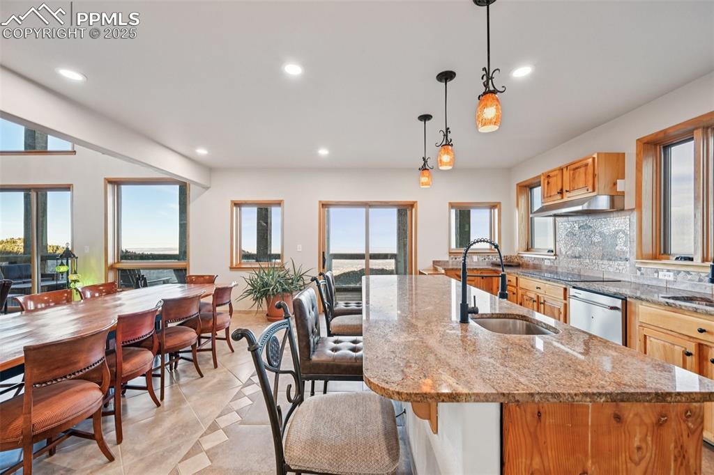 Image 16 of 50: Kitchen highlighting the spacious island and walk out to the back deck